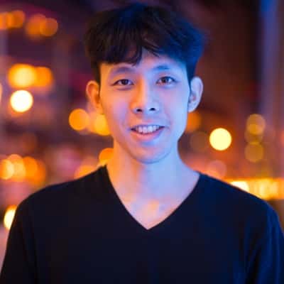 portrait-of-asian-man-smiling-outdoors-at-night-2021-08-27-14-37-31-utc-min